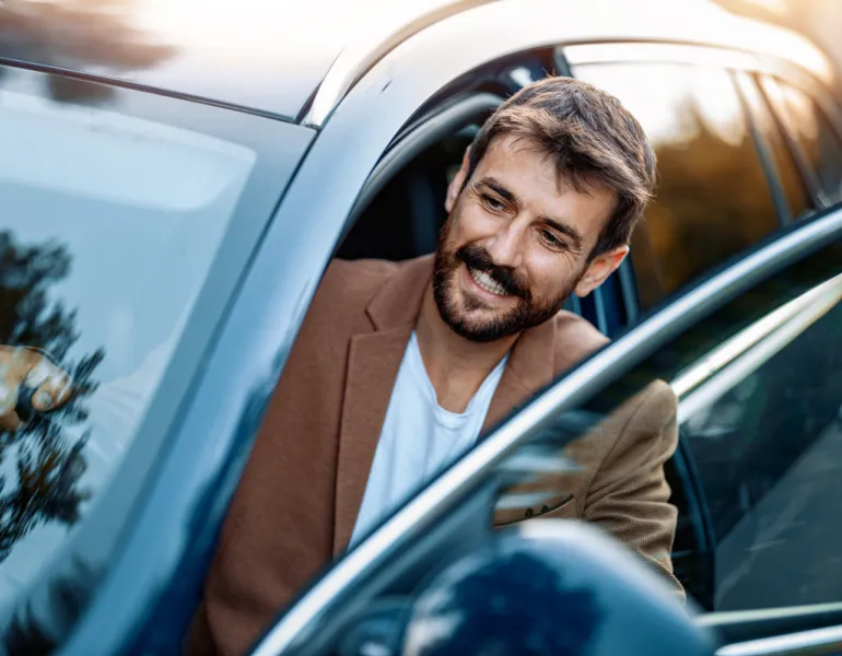 Businessman in car.Young businessman test drive new car.